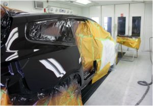 Car being repaired in spray booth
