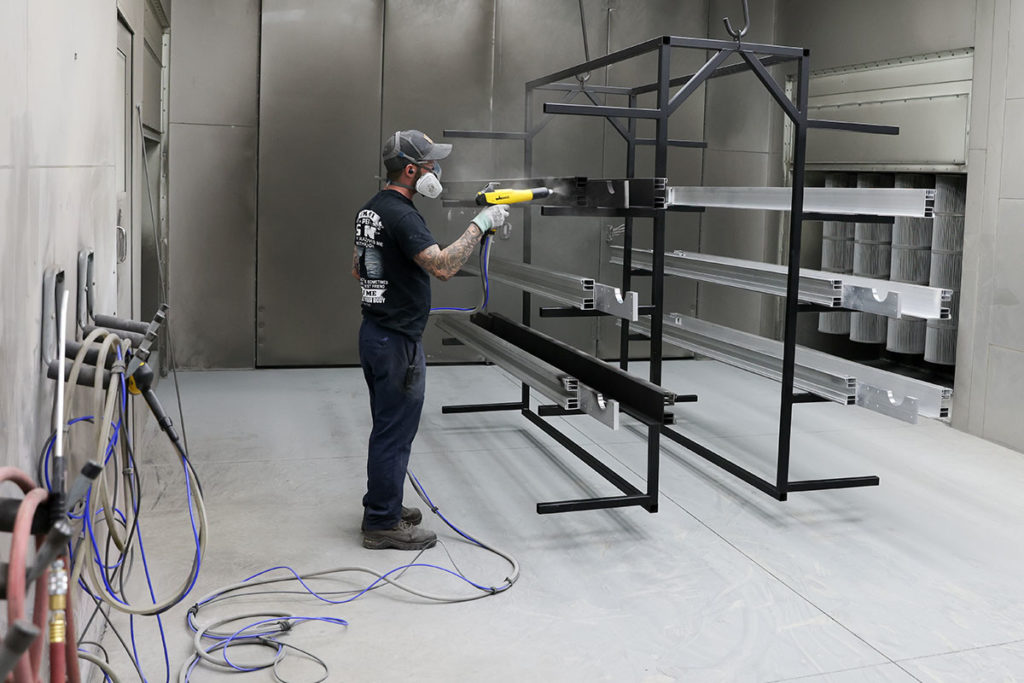 Powder coating parts with in a GFS Powder Coating Booth