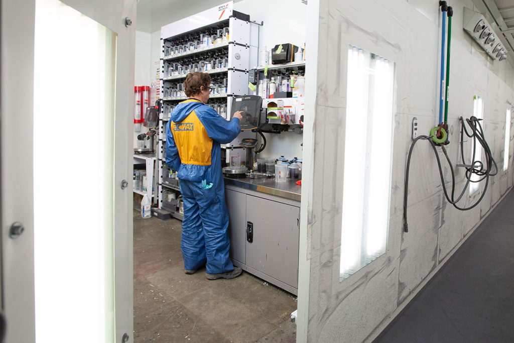 Paint technician mixing paint in a GFS Automotive Paint Mixing room